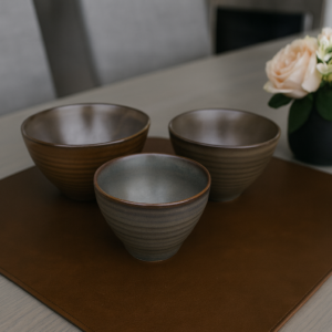 Espresso brown ceramic bowls with ribbed texture close-up