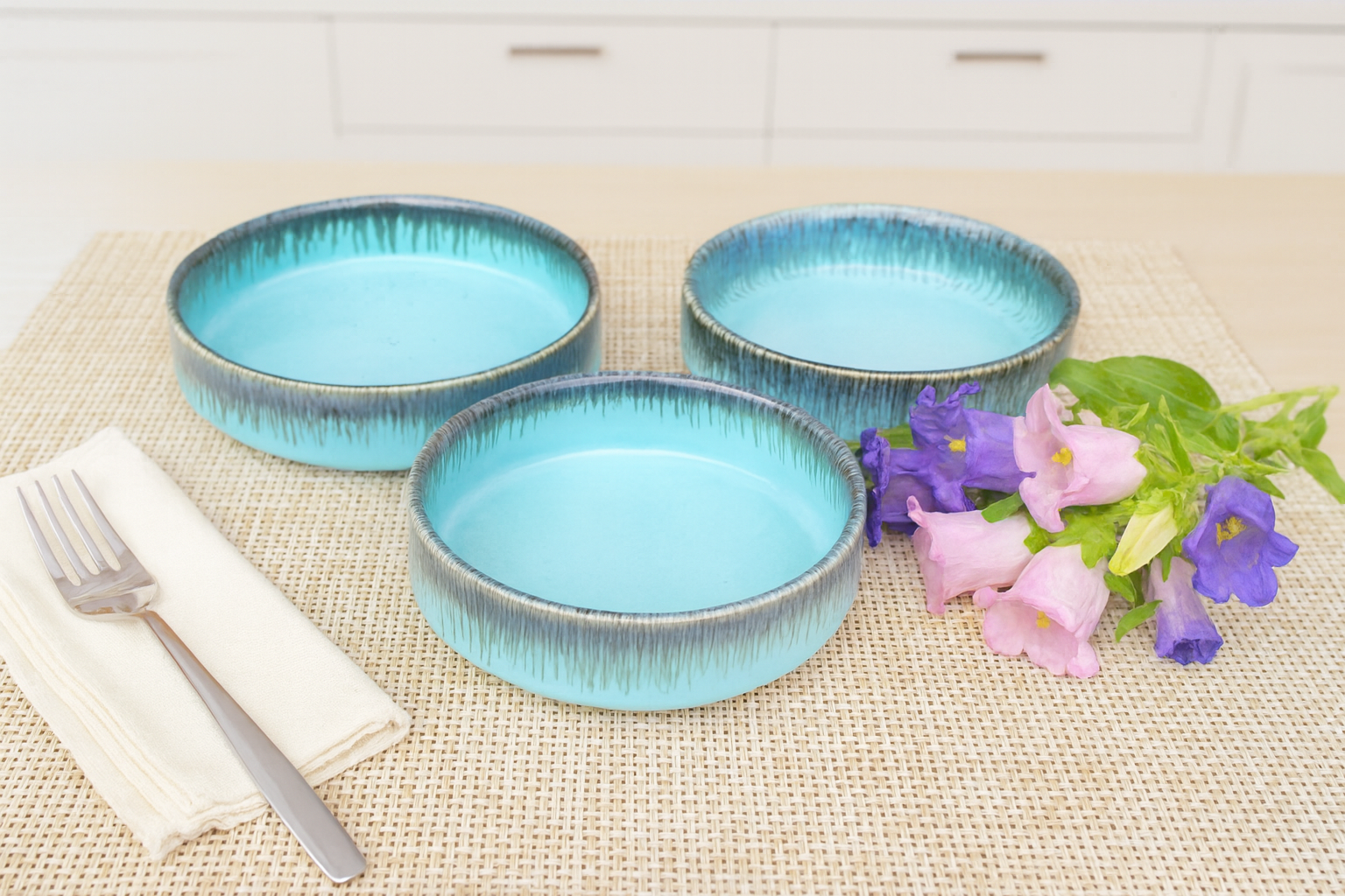 Set of ocean blue drip glaze serving bowls styled on table